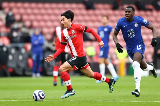 Southampton's Takumi Minamino (L) runs away from Chelsea's defender Kurt Zouma