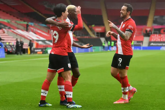 Takumi Minamino (L) celebrates with team-mates