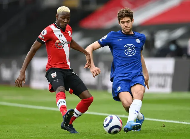 Marcos Alonso of Chelsea is challenged by Moussa Djenepo of Southampton