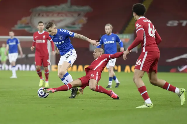 Lucas Digne (L) of Everton and Thiago Alcantara challenges for the ball