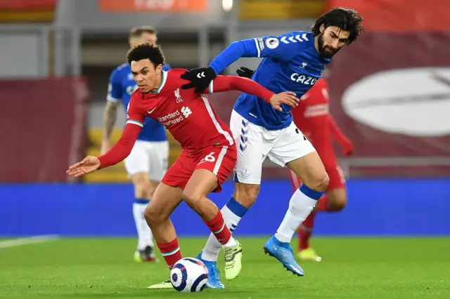 Liverpool's English defender Trent Alexander-Arnold (L) vies with Everton's Portuguese midfielder Andre Gomes