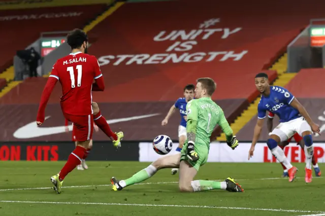 Jordan Pickford of Everton saves from Mohamed Salah of Liverpool