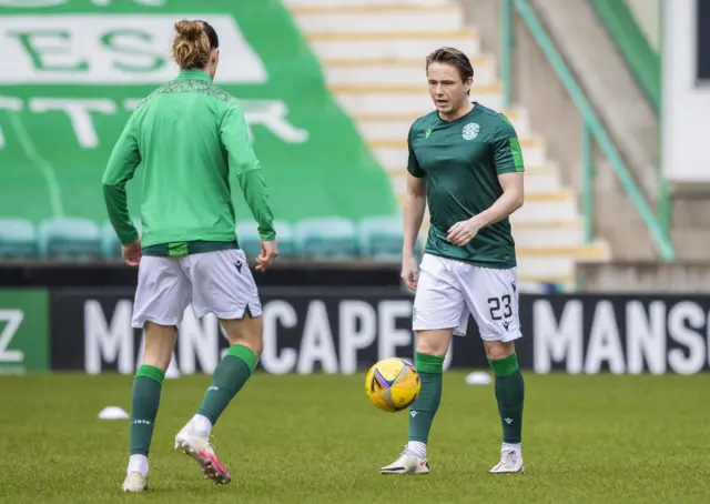 Scott Allan warms up alongside Jackson Irvine