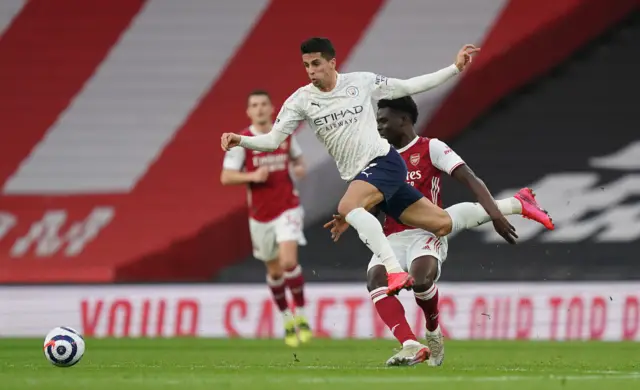 Manchester City's Joao Cancelo (left) and Arsenal's Bukayo Saka