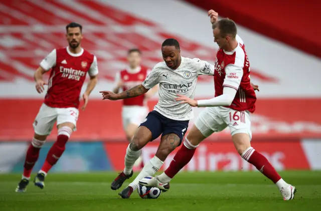 Raheem Sterling takes on Rob Holding