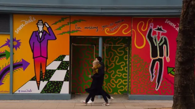 People walking past a shop
