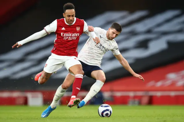 Arsenal's Gabonese striker Pierre-Emerick Aubameyang (L) vies with Manchester City's Portuguese defender Ruben Dias (R) during the English Premier League football match between Arsenal and Manchester City at the Emirates Stadium