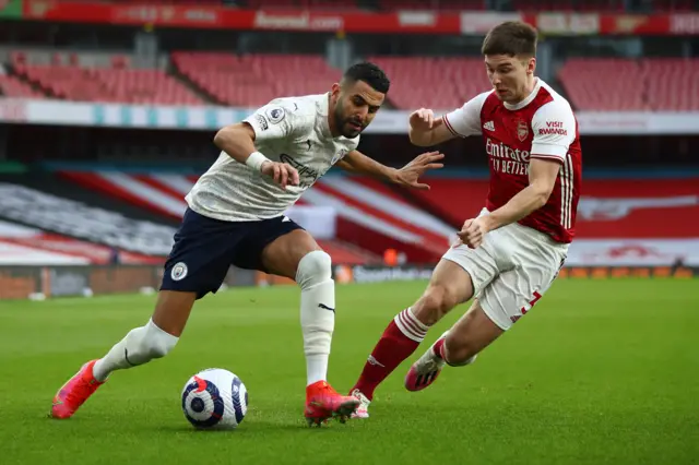 Riyad Mahrez of Manchester City is challenged by Kieran Tierney of Arsenal during the Premier League match between Arsenal and Manchester City at Emirates Stadium