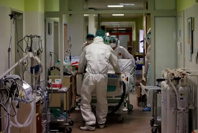 Medical staff transfer a patient suffering from Covid-19 from a fully occupied Intensive Care Unit (ICU) of the Nachod hospital, Czech Republic, on 11 February 2021