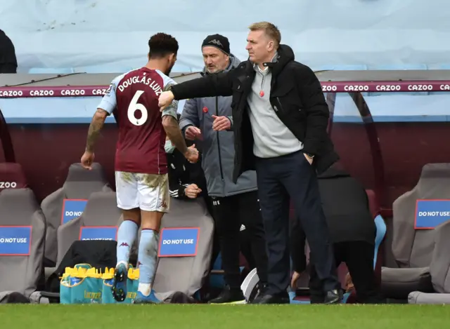 Dean Smith pats Douglas Luiz on the back