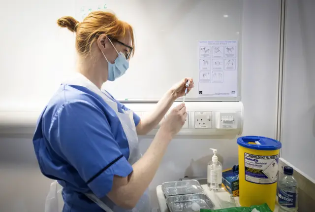 nurse preparing vaccine