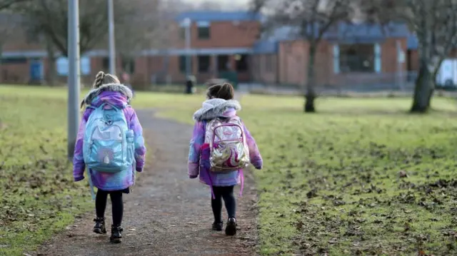 Pupils walk to Pitlochry High School on the first day back following the easing of the coronavirus disease (COVID-19) restrictions, in Pitlochry, Scotland,