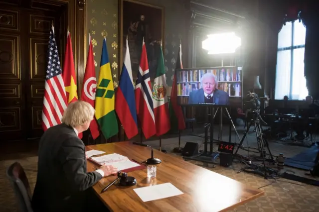 Boris Johnson watches a video address by Sir David Attenborough at a session of the UN Security Council on climate and security on Tuesday