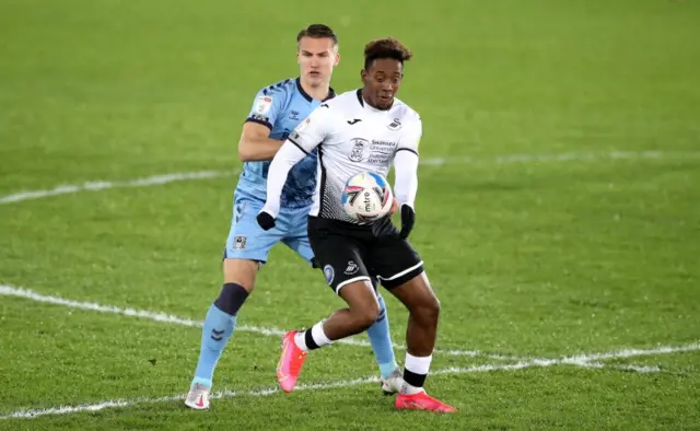 Swansea's Jamal Lowe (right) and Coventry City's Leo Ostigard battle it out