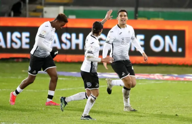 Swansea Citys Ben Cabango (right) celebrates scoring their side"s first goal of the game