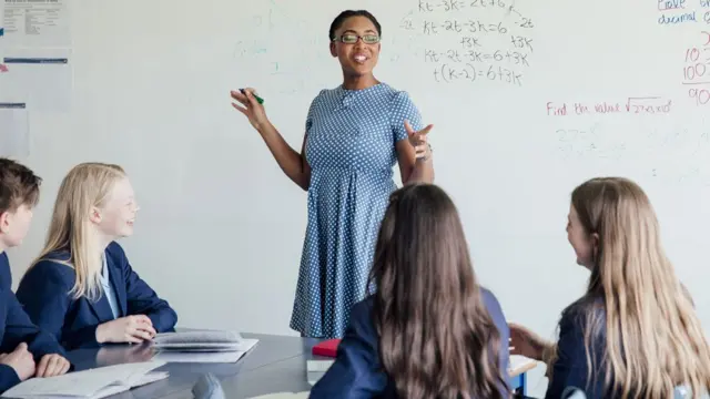 Teacher in her secondary school classroom