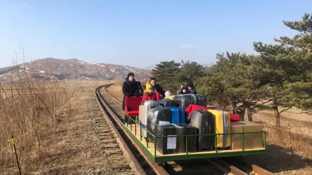 The group push themselves on a trolley