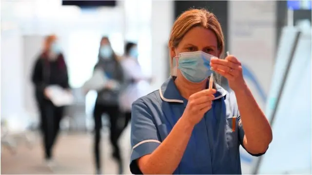 A nurse preparing a Covid vaccine