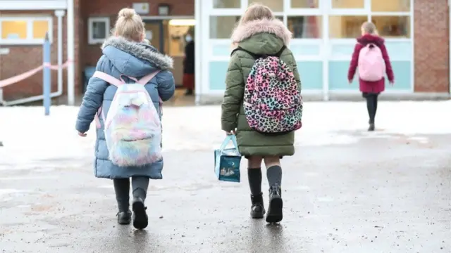 Children walk into a school