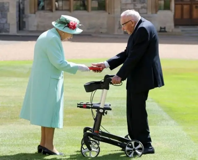 Captain Sir Thomas Moore receiving his knighthood from Queen Elizabeth II