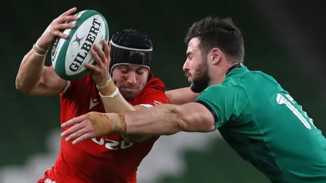 Wales full-back Leigh Halfpenny is tackled by Ireland centre Robbie Henshaw during the Autumn Nations Cup