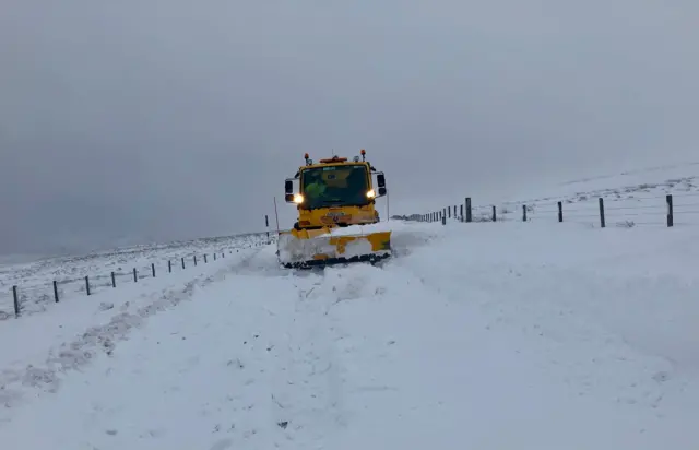 Snow plough on road in Nenthead