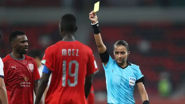 Edina Alves shows a yellow card