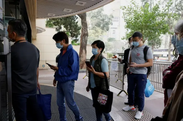 People queue up at a community vaccination centre to receive a dose of the Sinovac vaccine, in Hong Kong