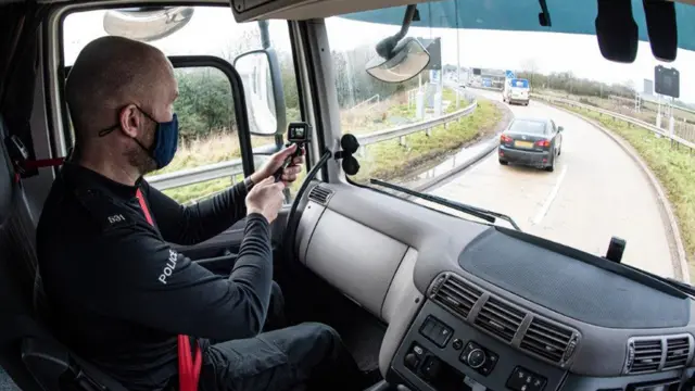 Police officer filming from lorry