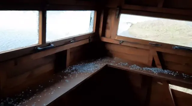 Smashed windows inside the hide