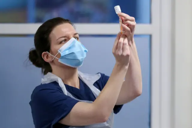 A health worker with a Covid vaccine