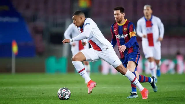 Kylian Mbappe sprints away from Lionel Messi