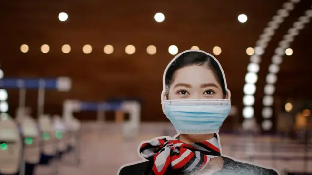 Cardboard cut out of a Japan Airlines stewardess wearing a protective face mask at Paris Charles de Gaulle airport in Roissy near Paris on 5 February 2021