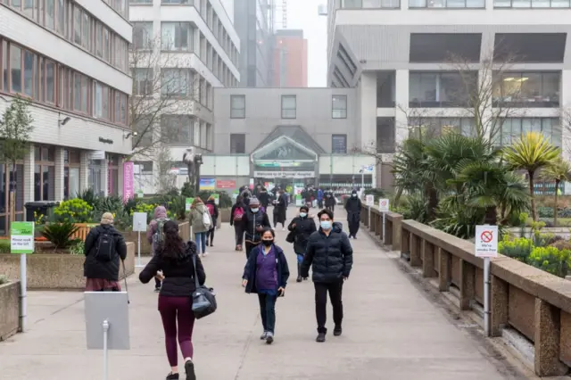 People wear masks outside St Thomas's Hospital in London