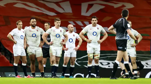 England stand and stare at the referee with hands on hips