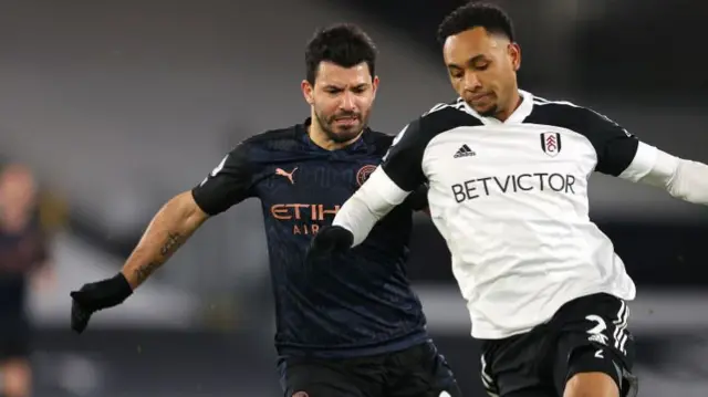 Kenny Tete of Fulham battles for possession with Sergio Aguero of Manchester City