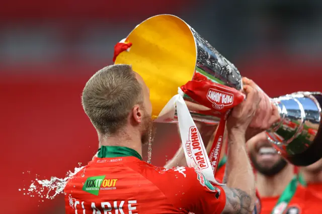 Tom Clarke for Salford drinks from the EFL Trophy