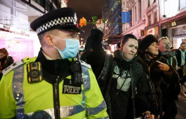 Protesters and police officer