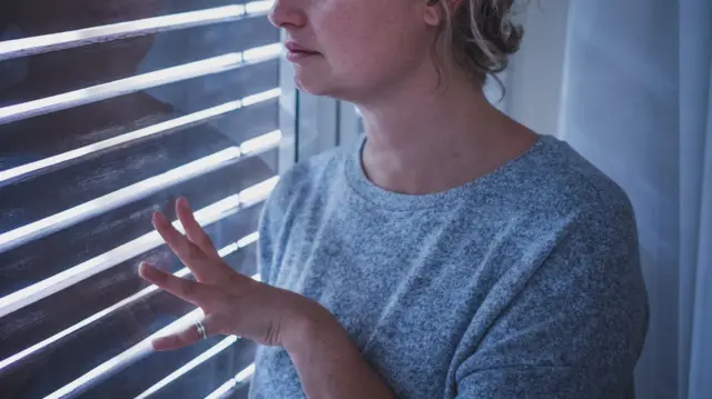 Woman stood by the window