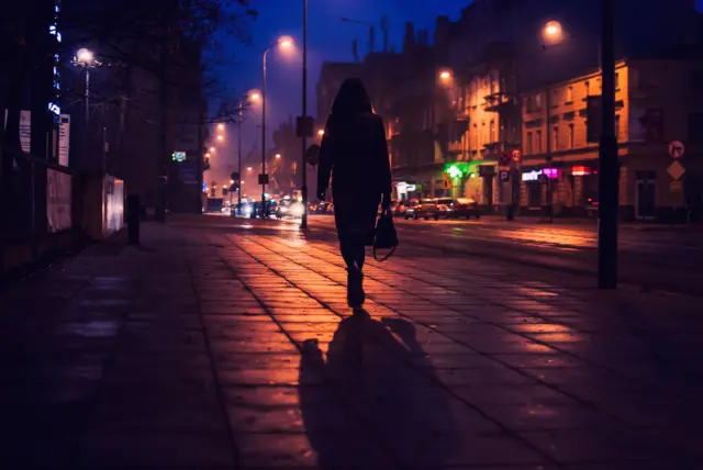 Woman walking alone at night