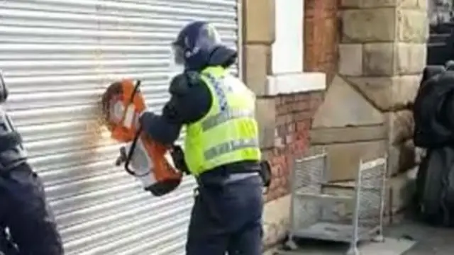 Police cut garage door with grinder