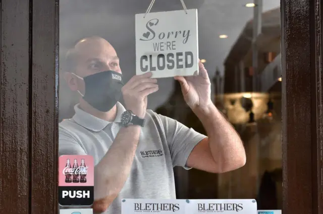 Man with closed sign