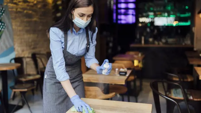 Waiting staff clean a table