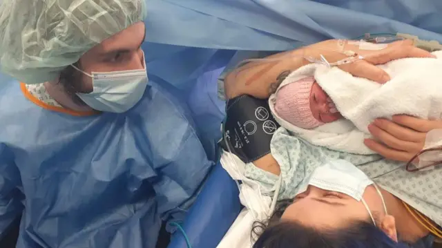 Jordan Anderson with his wife and baby daughter