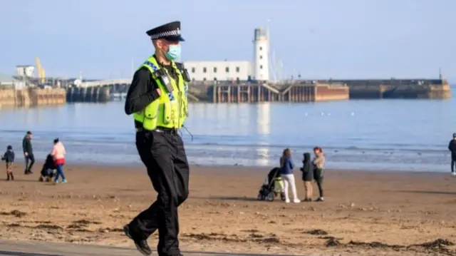 A police officer patrols the seafront in Scarborough,