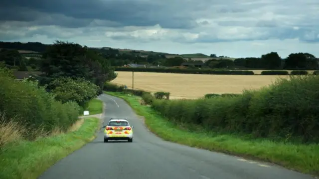 Police car on a country road