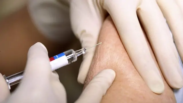 Woman receiving an influenza vaccination - generic