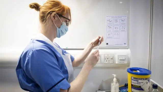 A nurse prepares a coronavirus vaccine - generic