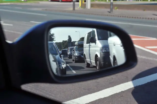 traffic queue reflecting in wing mirror