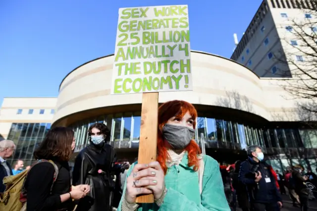 Woman holds a placard in The Hague